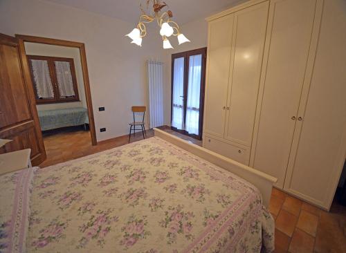 a bedroom with a bed and a dresser and a window at Agriturismo Le Capanne in San Dalmazio