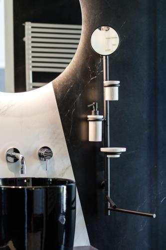 a bathroom with a black sink and a mirror at MaisonMe Boutique Hotel in Bardolino