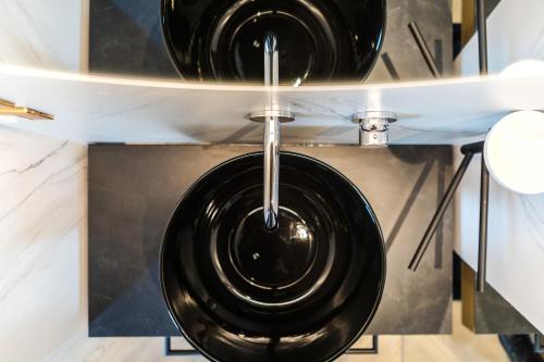 a black bowl hanging from a ceiling in a kitchen at MaisonMe Boutique Hotel in Bardolino