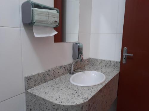 a bathroom counter with a sink and a phone at Pousada Convento da Conceição in Olinda