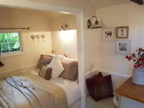 A bed or beds in a room at Borthwickbrae Shepherd's Hut