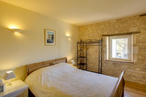 a bedroom with a bed and a window at Charente Chambres d'Hôtes - B&B in Bernac
