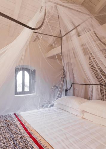 a bedroom with a bed in a tent at Castello di Gabiano in Gabiano