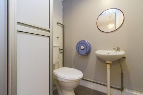 a bathroom with a toilet and a sink at Cocoa Mews Cafe and Homestay in George Town