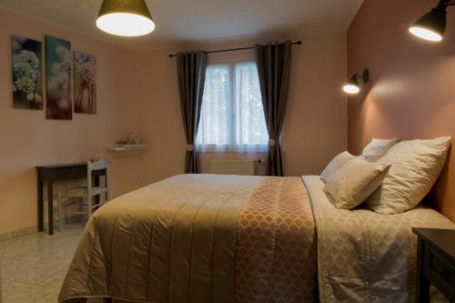 a bedroom with a bed and a window at Les Rendzines in Nuisement-sur-Coole