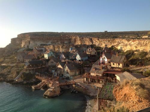 an aerial view of a village on a cliff at Francis Flats Modern Penthouse in Mellieħa