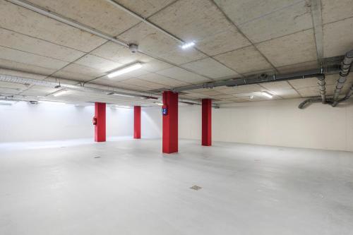 an empty parking lot with red poles in a room at MaisonMe Boutique Hotel in Bardolino