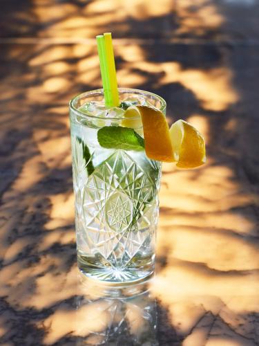 a glass of water with a lime and orange slices at Mama Shelter Belgrade in Belgrade