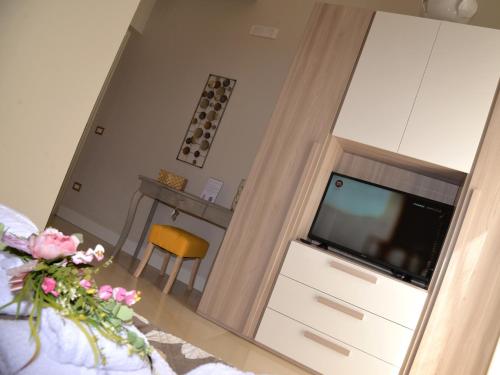a living room with a television and a dresser at CASA FELICE Suite Room in Taranto