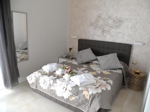 a bedroom with a bed with towels on it at CASA FELICE Suite Room in Taranto