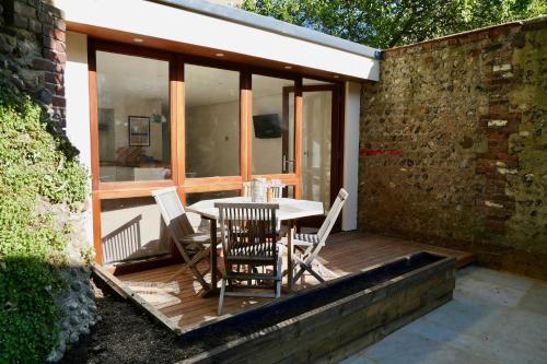 a wooden deck with a table and chairs on it at Hidden Gem in Brighton & Hove