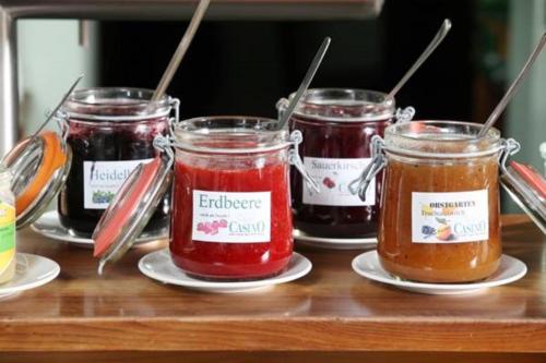 a group of four jars of jam on a table at AKZENT Hotel Altes Casino in Fulda