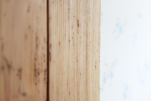 a close up of a wooden wall next to a window at Logis Hôtel Ettenheim in Strasbourg