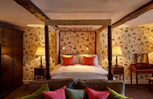 a bedroom with a bed and a couch at Ockenden Manor Hotel & Spa in Cuckfield