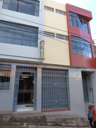 a building with a man walking in front of it at HOSTAL MILAGROS Inn in Puno
