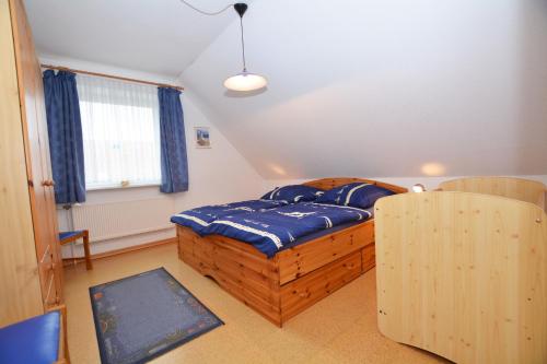 a bedroom with a wooden bed and a window at Haus Sonja in Büsum