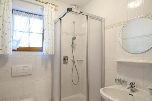 a bathroom with a shower and a sink at Alpasella Ferienwohnungen in Sankt Gallenkirch