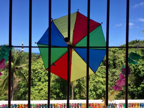 a colorful kite is hanging from a fence at Pousada Convento da Conceição in Olinda