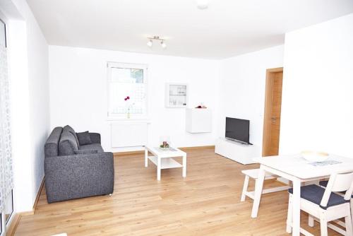 a living room with a couch and a table at Krug-Apartments in Ebelsbach