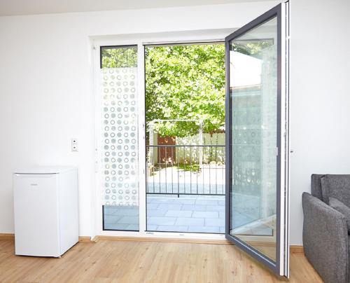 a living room with a sliding glass door at Krug-Apartments in Ebelsbach