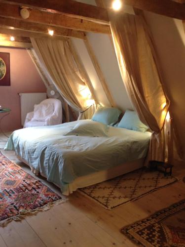 a bedroom with a bed in an attic at Le Carroy Brion in Cinais