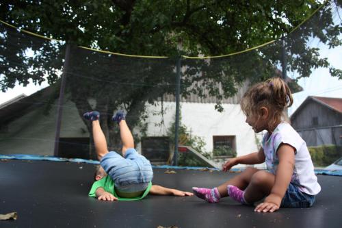 two little girls playing on a trampoline at Ferienhof Naderhirn - Bauernhof in Wegscheid