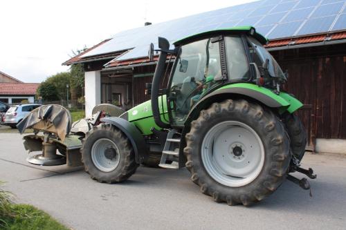a green tractor parked in front of a building at Ferienhof Naderhirn - Bauernhof in Wegscheid