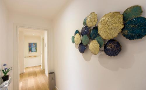 a wall with blue and yellow decorations on a wall at Jolie Julie Accomodation in Sassari