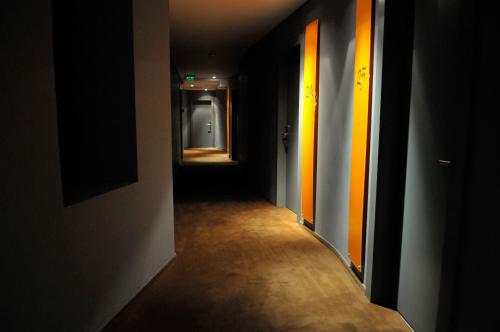 a hallway with orange and yellow stripes on the walls at Sarroglia Hotel in Bucharest