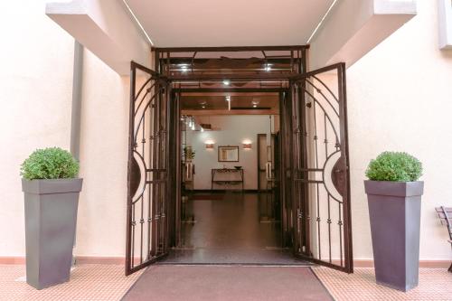 an open door with two potted plants in a hallway at Le Terrazze in Follonica