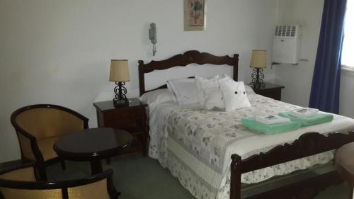 a bedroom with a bed with two towels on it at Hotel Zapata in La Cumbre