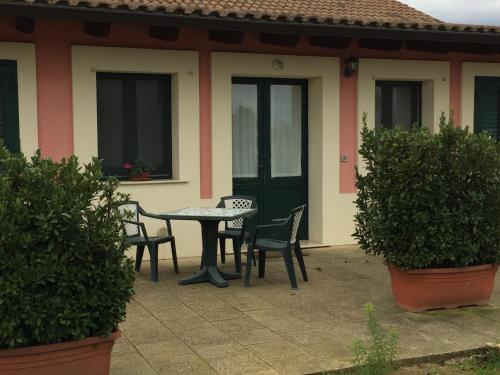 a patio with a table and chairs in front of a house at Agriturismo Arangèa in Lequile