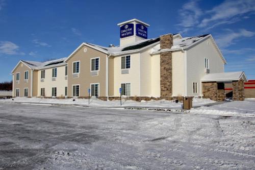a large building with a sign on top of it at Cobblestone Inn & Suites - Carrington in Carrington