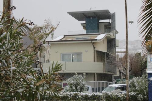 a building with snow on it in a city at Residenza Alpaluba in Vasto