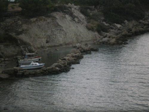 a boat is docked on the shore of a river at Pefkos Filoxenia in Pefki Rhodes