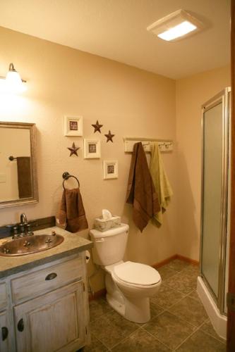 a bathroom with a toilet and a sink at Sawin' Logs Inn in Devils Tower