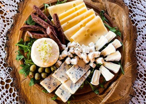 a plate of cheese and other foods on a table at Rancho Zapotoczny in Łagów
