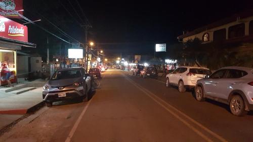 a street with cars parked on the side of the road at Hotel Giada in Sámara