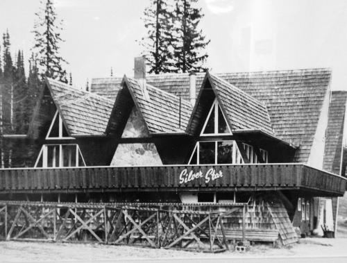 a black and white photo of a building with a roof at The Pinnacles Suites & Townhomes in Silver Star