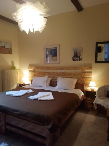 a bedroom with a large bed with towels on it at Maison Christiana's in Kalavrita