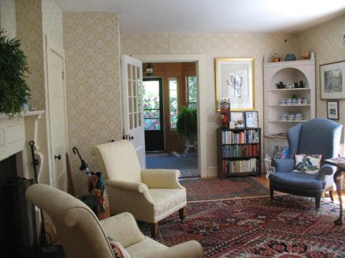a living room with two chairs and a couch at Harbourside Inn in Northeast Harbor
