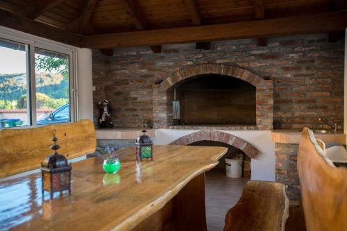 a kitchen with a stone fireplace and a counter top at Apartments Dania in Lopar