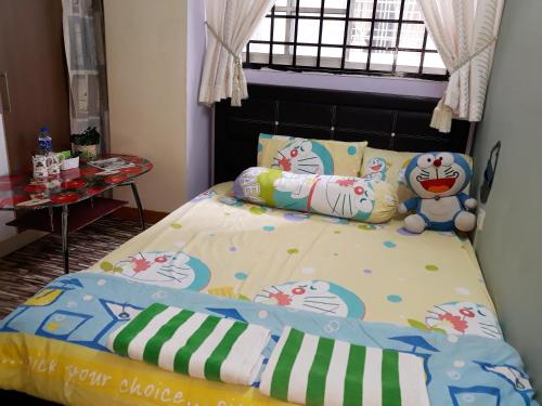 a bedroom with a bed with hello kitty pillows at A room in Aparnt Sri Impian in Johor Bahru