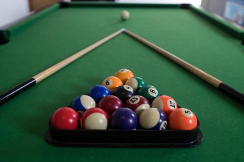 a tray of billiard balls on a pool table at Apartments Dania in Lopar