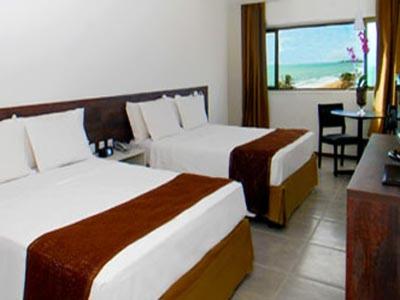 um quarto de hotel com duas camas e uma mesa em Flat no Hotel Ritz Suites em Maceió