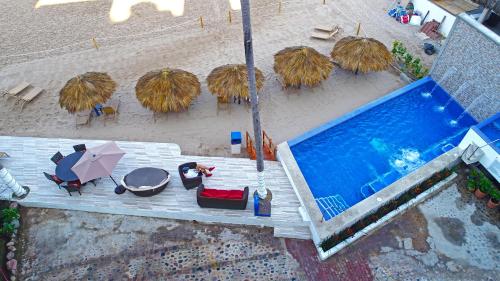 an overhead view of a swimming pool with chairs and umbrellas at Vallarta Shores Beach Hotel in Puerto Vallarta