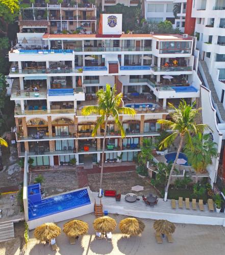 an aerial view of a building with a pool and palm trees at Vallarta Shores Beach Hotel in Puerto Vallarta