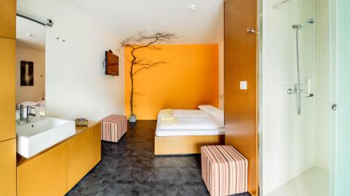 a bathroom with a tree on the wall at Hotel Sanje ob Soči ***/**** in Bovec