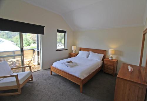 a bedroom with a large bed and a balcony at Stones-Throw in Margaret River Town