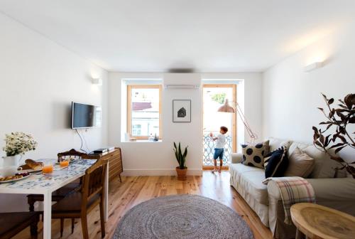 a child is standing in a living room at Cozy Lisbon Graça in Lisbon